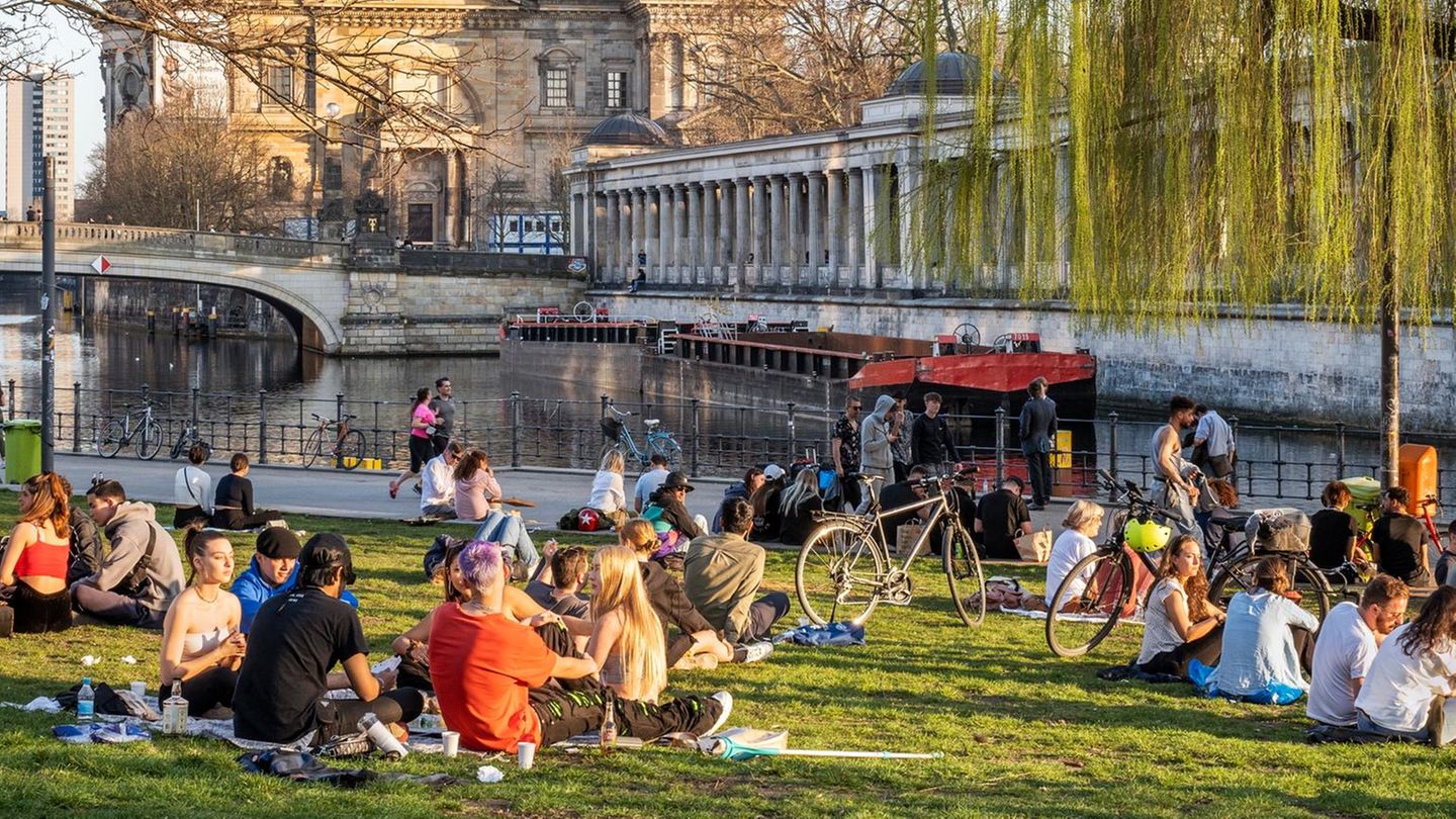 Menschen entspannen sich auf einer Wiese mit Blick auf Museumsinsel und Berliner Dom Menschen entspannen sich auf einer Wiese mit Blick auf Museumsinsel und Berliner Dom