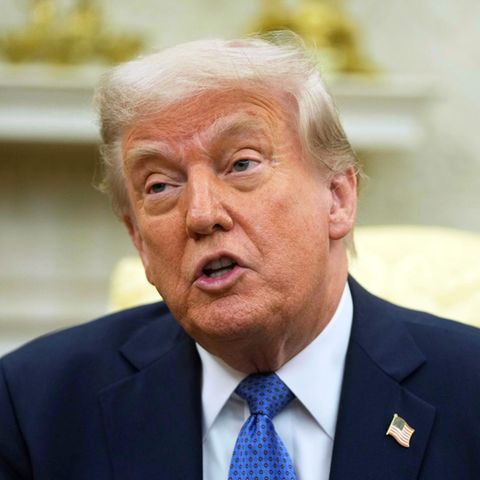 US President Donald Trump sits in the White House and speaks
