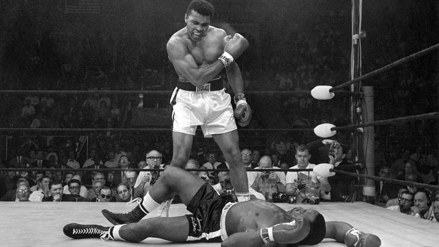 Ali nach gewonnenem Kampf gegen Sonny Liston, der am Boden liegt: Ali ballt die Faust und schaut auf ihn runter