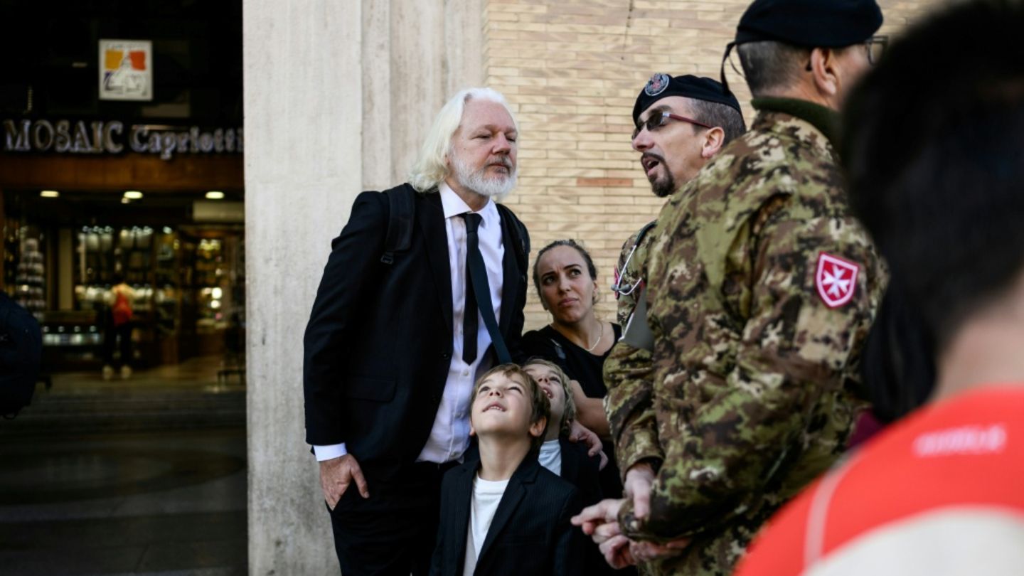 Assange mit Familie und Sicherheitskräften