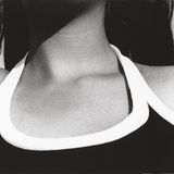 Ein Frauentorso in einem schwarz-weißen Shirt