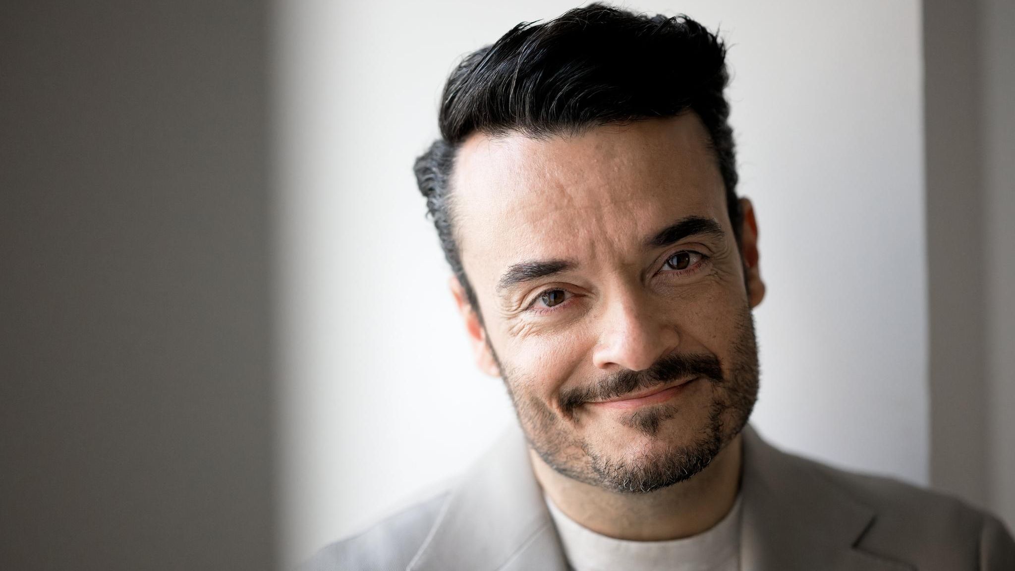 Giovanni Zarrella schaut in die Kamera, er trägt einen grauen Anzug