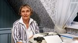 Astrid Lindgren am Tisch mit ihrer Schreibmaschine