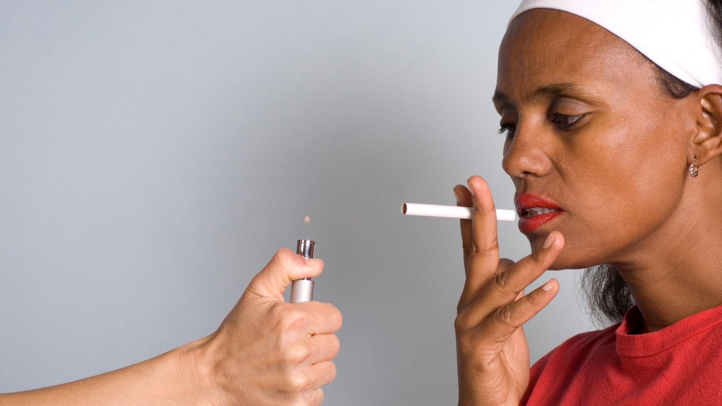 A woman can be given fire for her cigarette