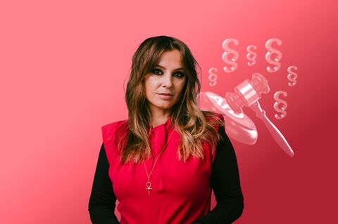 Jagoda Marinić, eine Frau mit langen Haaren schaut in die Kamera. Hinter ihr ist eine Illustration zum AfD-Verbot