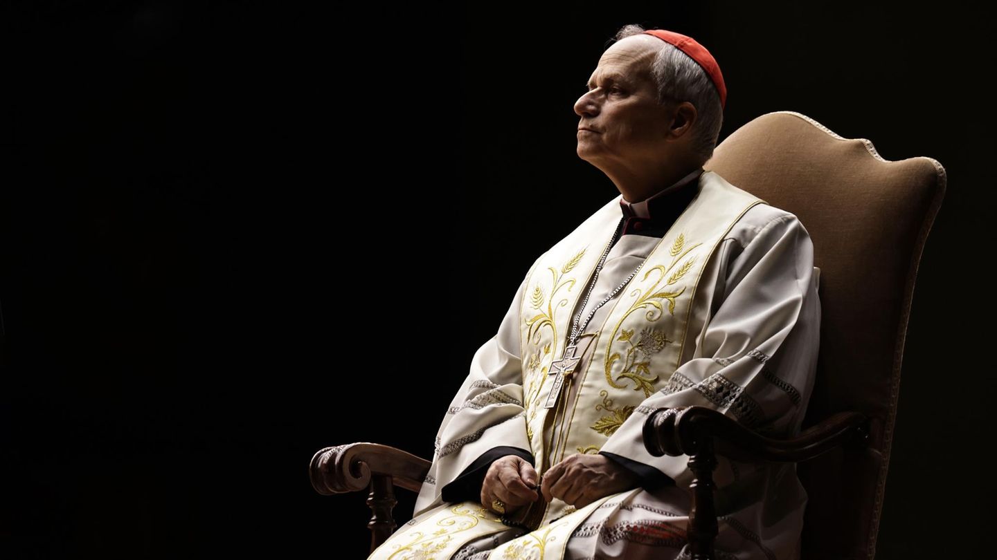 Robert Francis Prevost sitzt auf einem Stuhl vor schwarzem Hintergrund