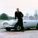 Sean Connery lehnt am Set von "Goldfinger" an einem Aston Martin, Modell DB5