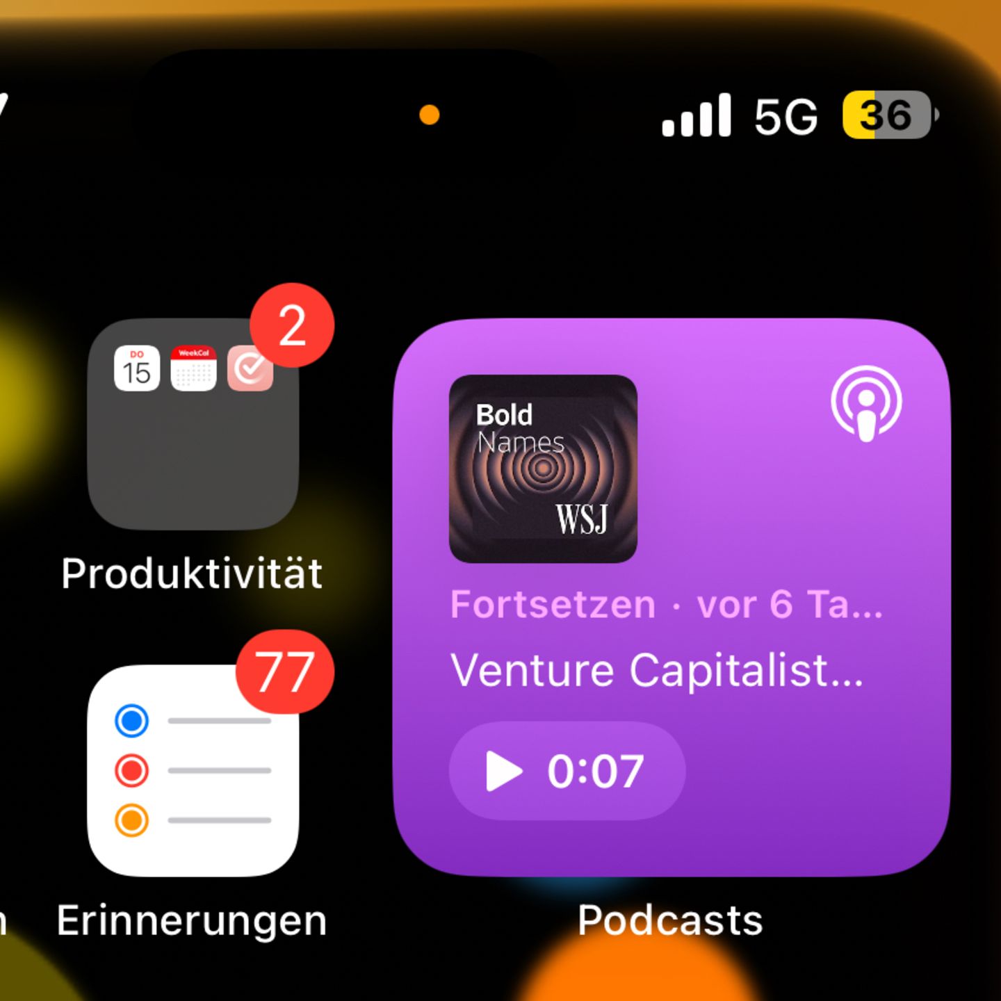 Ein Screenshot eines iPhones zeigt einen gelben Punkt am oberen Rand
