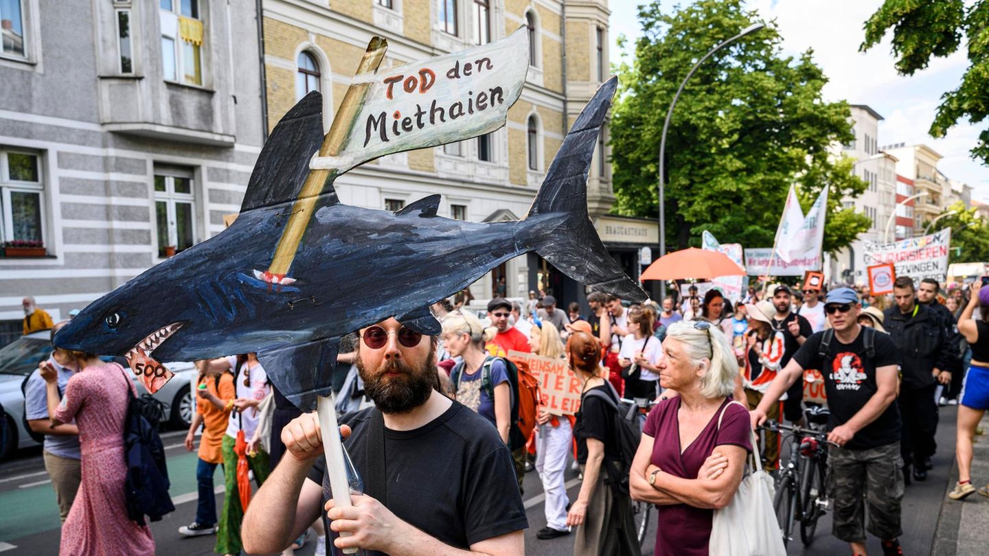 Ein Mann hält einen selbstgemalten Miethai in die Höhe: Demonstration für günstige Wohnungsmieten in Berlin Ein Mann hält einen selbstgemalten Miethai in die Höhe: Demonstration für günstige Wohnungsmieten in Berlin