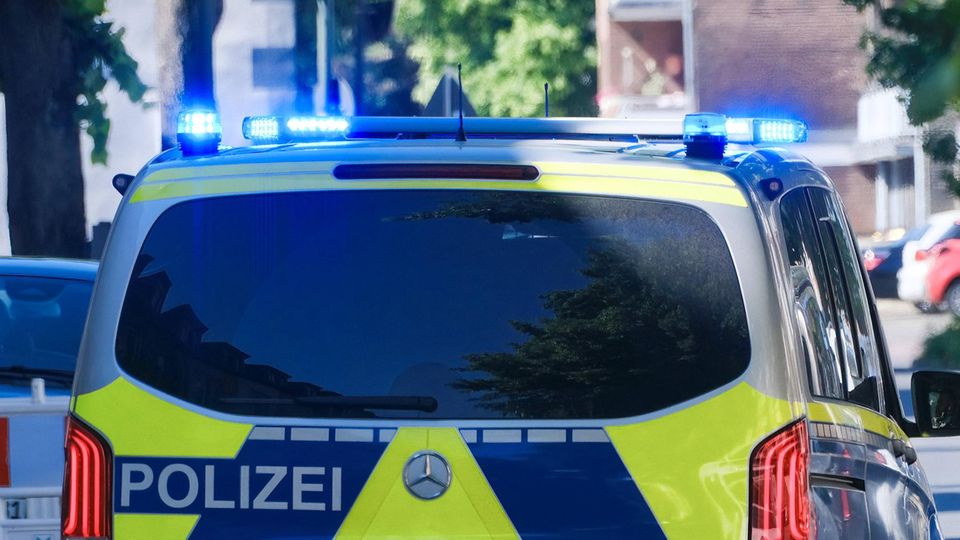 Ein Polizeiwagen in NRW fährt mit Blaulicht zu einem Einsatz