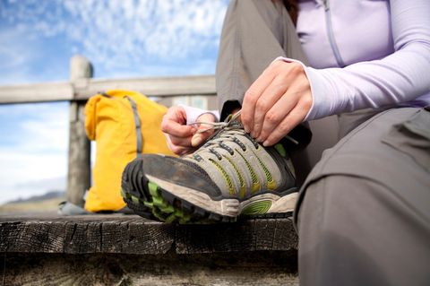 A female tying her shoe