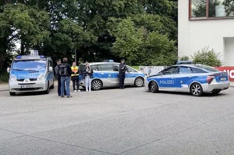 Mehrer Streifenwagen steher vor der Schule