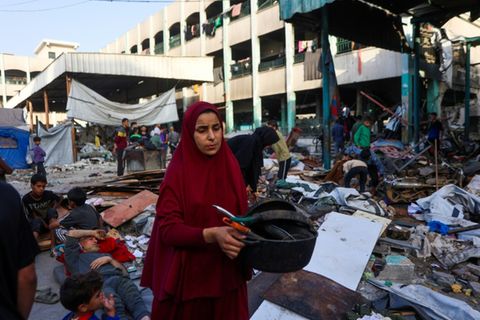 Frau in Trümmern von zerstörtem Gebäude in Gaza-Stadt