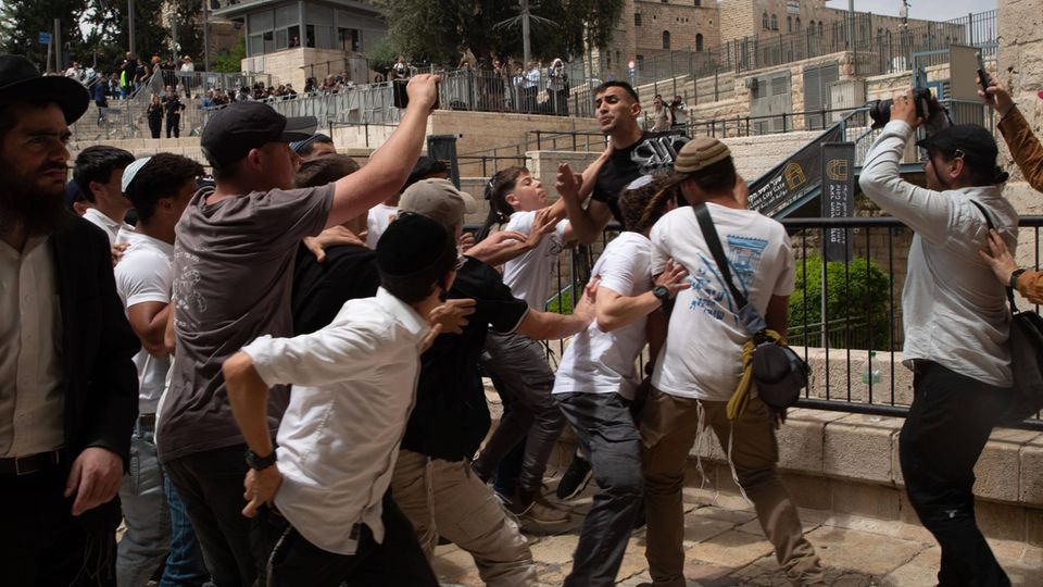 Right -wing extremist Israeli activists come together with a Palestinian man