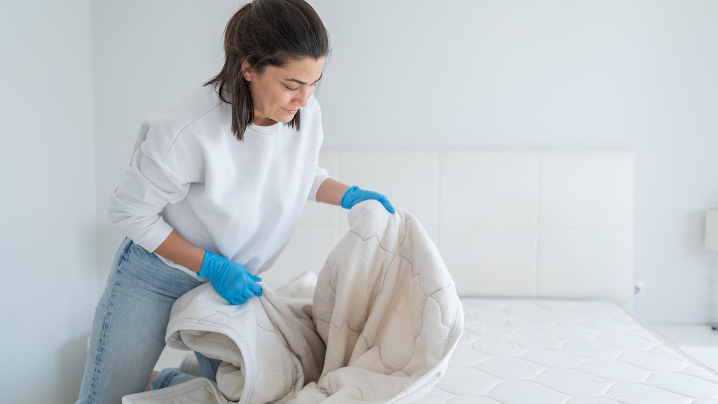 Dealnews: Eine Frau zieht einen Matratzenschoner auf die Matratze
