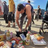 Ein Mann betrachtet das, was er ergattern konnte: Ein paar Dosen, Brot, Speiseöl und Mehl scheinen dazuzugehören