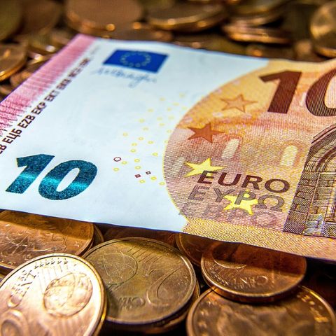 Business certificates and money coins
