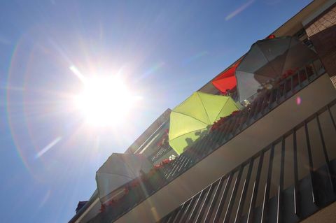 Symbolbild Hitze: Sonnenschirme auf einem Balkon