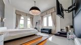 Das Bett im Schlafzimmer thront auf einer Art Podest