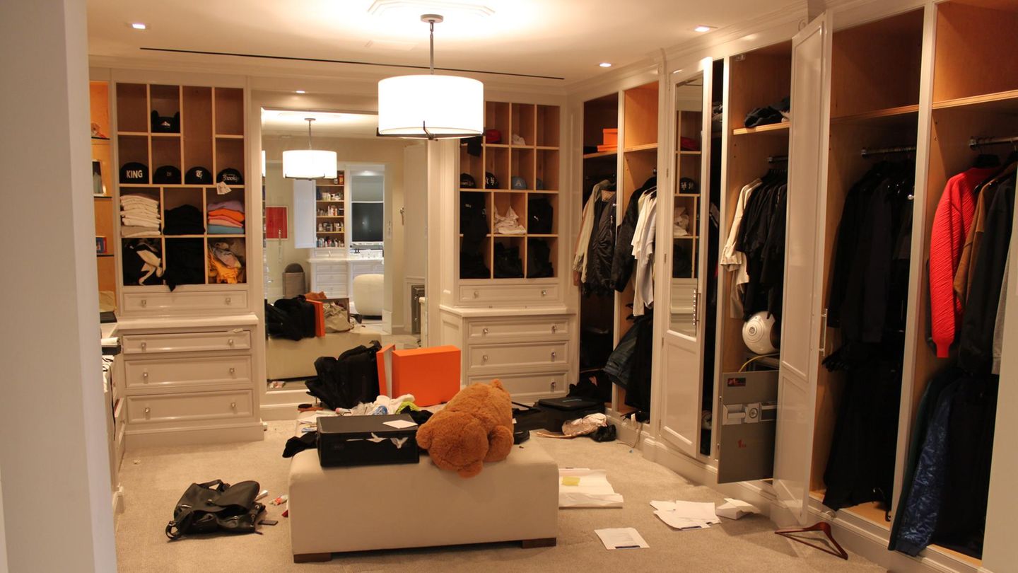 Eines der Ankleidezimmer war nach der Durchsuchung verwüstet – Taschen, Kisten und Dokumente blieben teils offen stehen. Und mittendrin: ein riesiger Plüschteddy