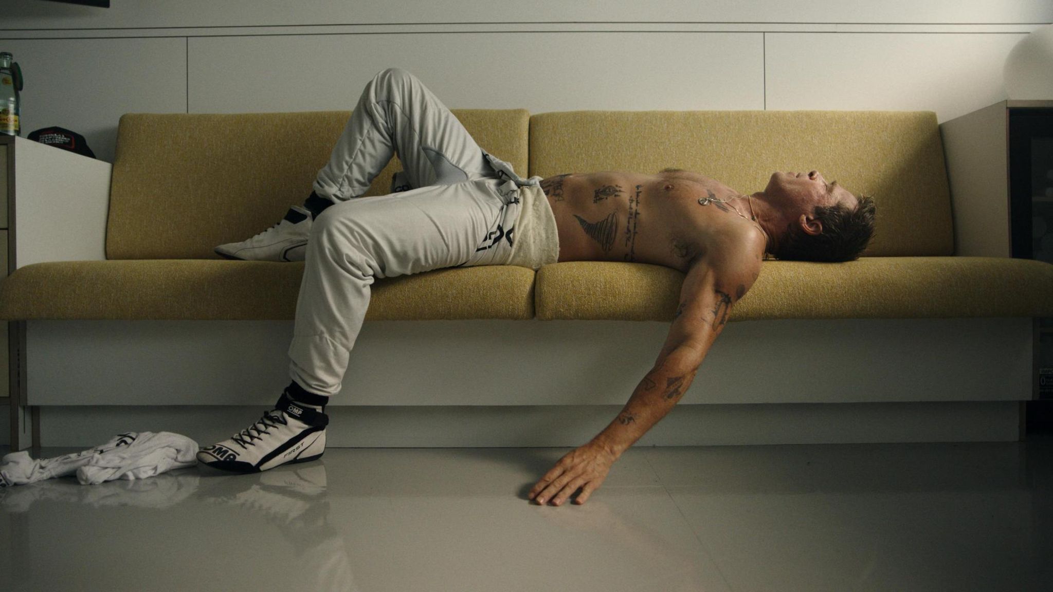 Oldtimer mit Tattoos: Szene aus "F1" mit Sonny Hayes (Brad Pitt), erschöpft nach einem Formel-1-Rennen