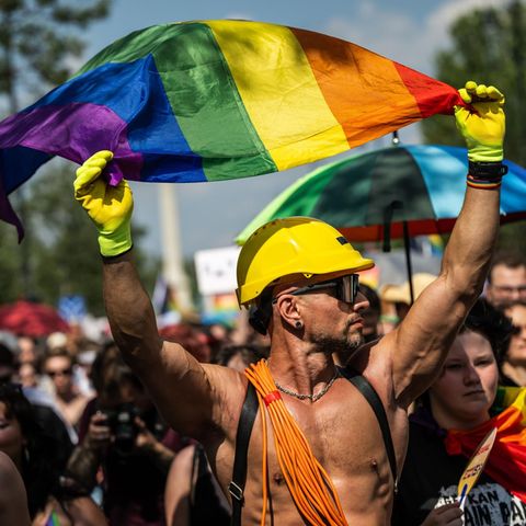 A man swings a rainbow flag at the Pride Parade in Hungary