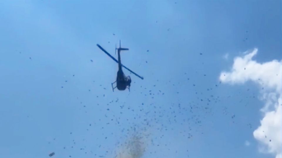 Das Foto zeigt einen Helikopter in Detroit, aus dem Geldscheine regnen