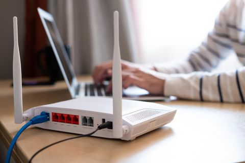 Wlan Reichweite: WLAN-Router steht auf einem Schreibtisch