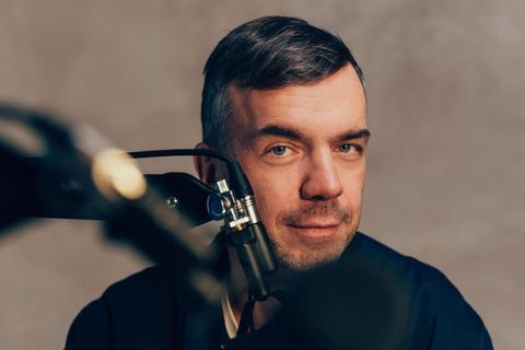 Matze Hielscher sitzt vor einem Mikrofon