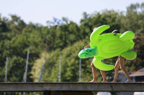 Kinder mit Schwimmhilfe an Badesee