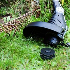 Bosch-Rasentrimmer gegen Holzzaun aus nächster Nähe