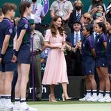 Kate in rosa auf dem Centre Court, sie begrüßt sie Ballkinder, die aufgereiht da stehen