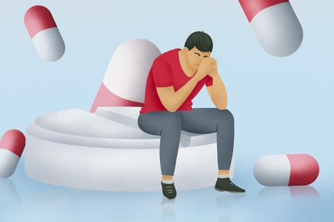 Illustration trauriger Mann mit Tabletten