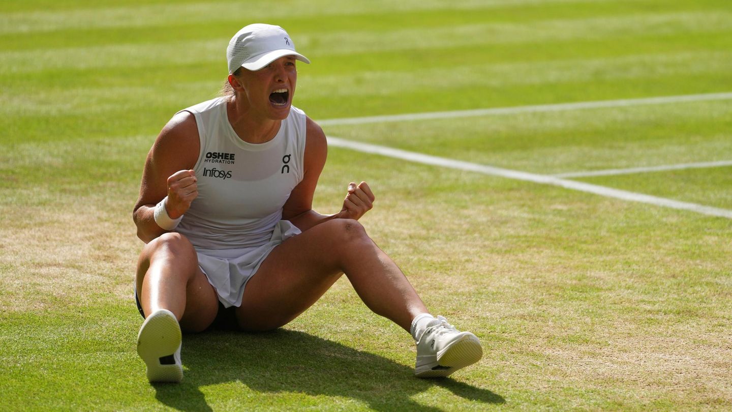 Nach ihrem Sieg in Wimbledon sitzt Iga Swiatek jubelnd auf dem Boden