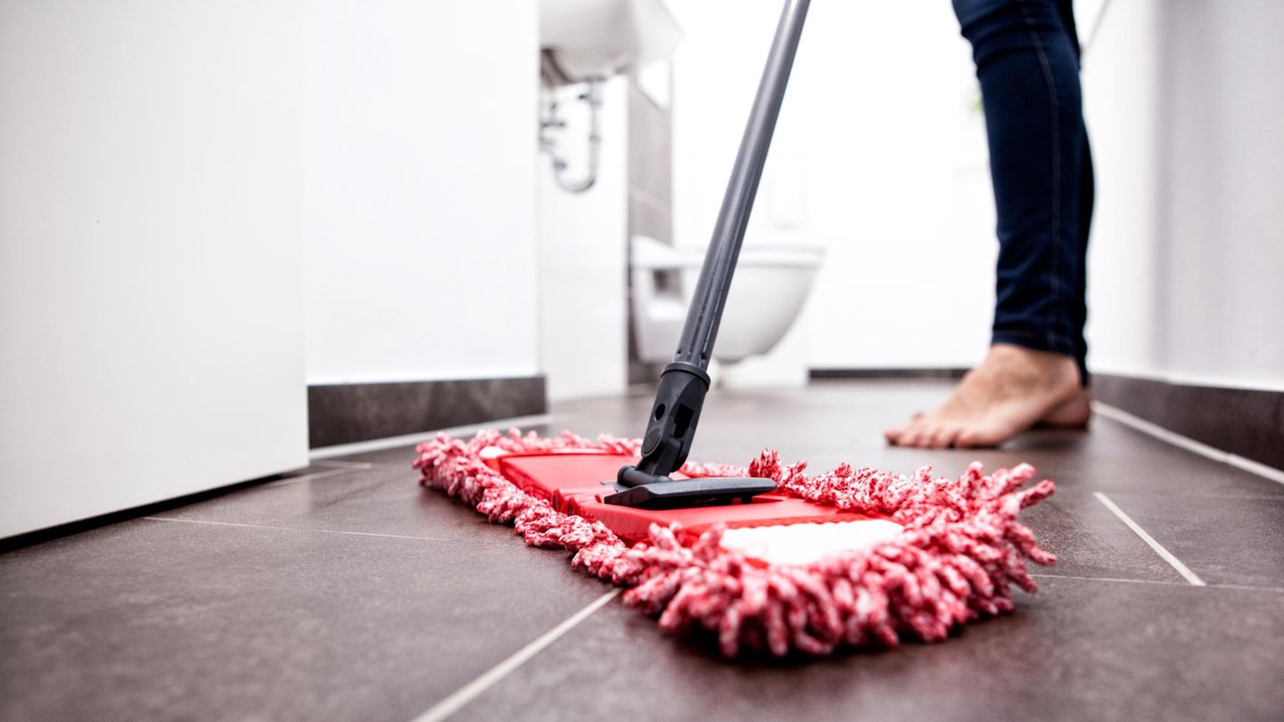 Woman wiping the floor in bathroom