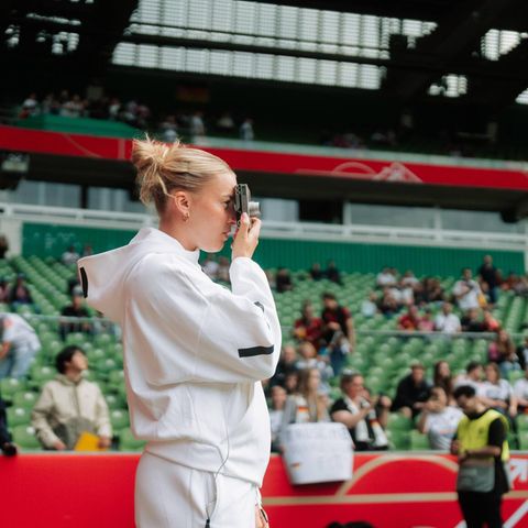 Laura Freiegel looks through her camera in the Weser Stadium in the Bremen Weser Stadium before a DFB game