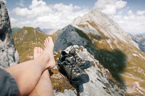 Austria, Tyrol, point of view shot of man's legs in mountainscape