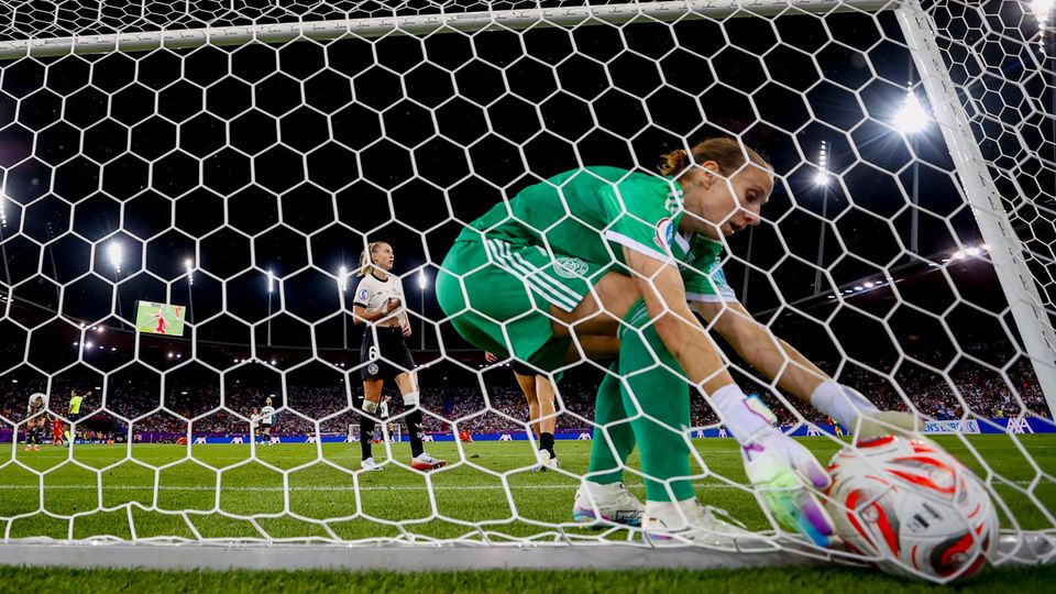 Ann-Katrin Berger gets the ball from the network after the goal in the European Championship semi-final