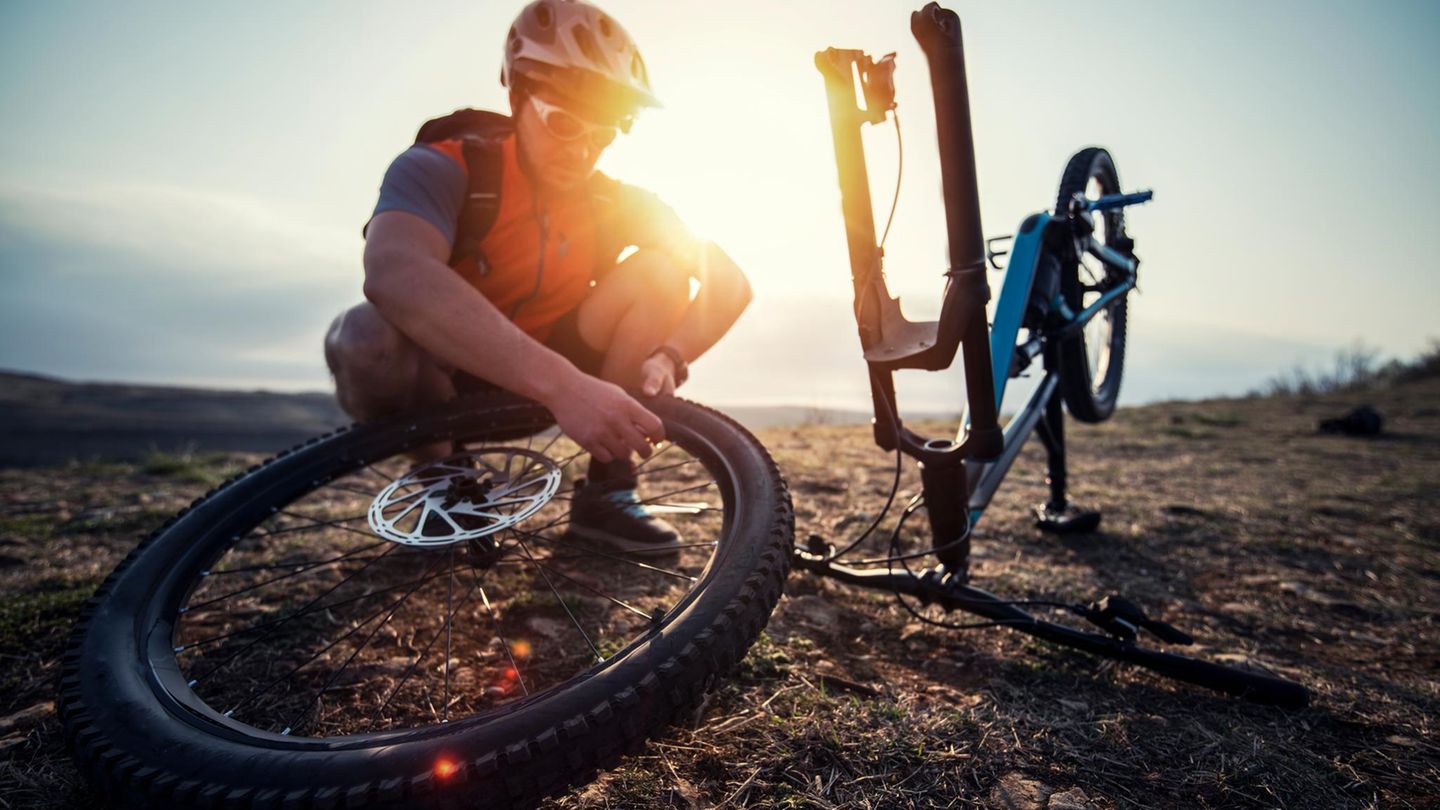 Mountainbiker repariert einen flachen Reifen