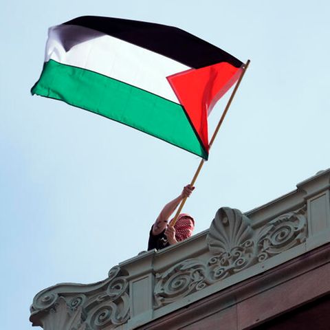A protesting student swings Palestina's flag on the campus of Columbia University