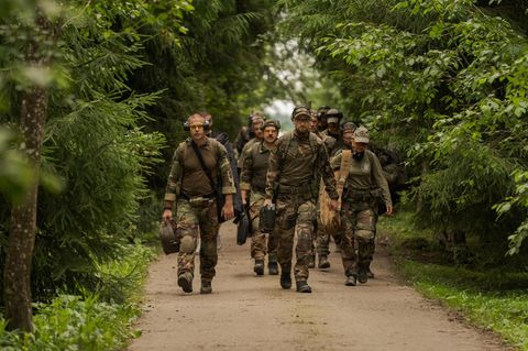 Soldaten laufen einen Waldweg in Litauen entlang
