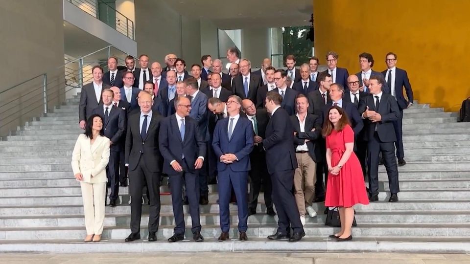 Vorstände der DAX Unternehmen mit Friedrich Merz Vorstände der DAX Unternehmen stehen aufgereit mit Friedrich Merz für ein Foto auf einer Treppe.