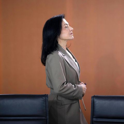 Katherina Reiche stands behind a row of chairs