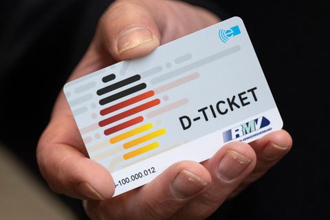 Eine Hand hält ein Deutschlandticket