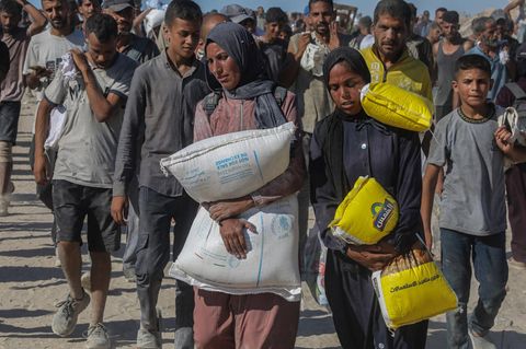 Palästinenser mit Hilfsgütern nach Angriffen Israels