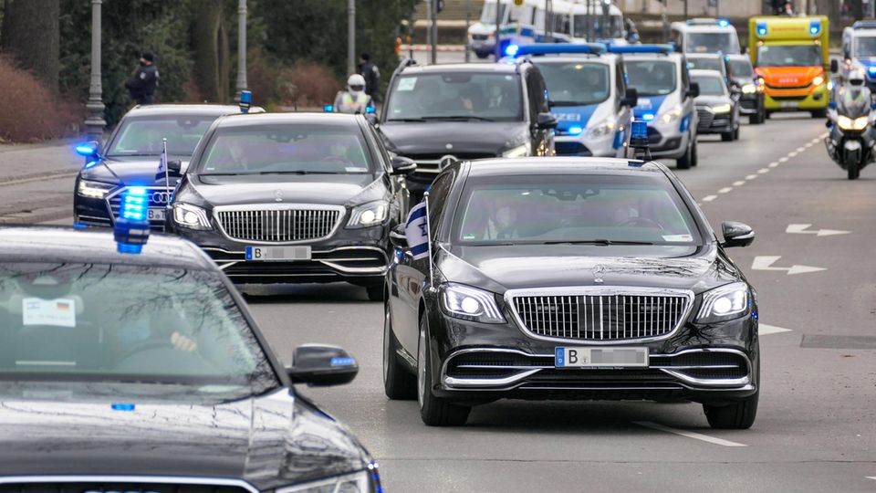 Government cars: a column of black limousines from the Mercedes S-Class Maybach and police and ambulances