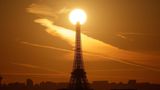 Paris, Frankreich. Ein Schnappschuss, für den man Geduld braucht: Die Sonne erhebt sich über die Spitze des Eiffelturms. Es wirkt, als trage der Turm eine riesige Leuchtkugel, die den Pariser Morgenhimmel in warme Goldtöne taucht