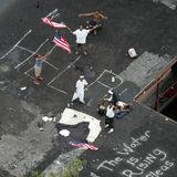 Ein Hilferuf in Weiß: Diese Menschen haben sich vor dem Wasser auf ihr Hausdach geflüchtet. Sie schwenken amerikanische Flaggen, um Rettungshubschrauber auf ihre Notlage aufmerksam zu machen