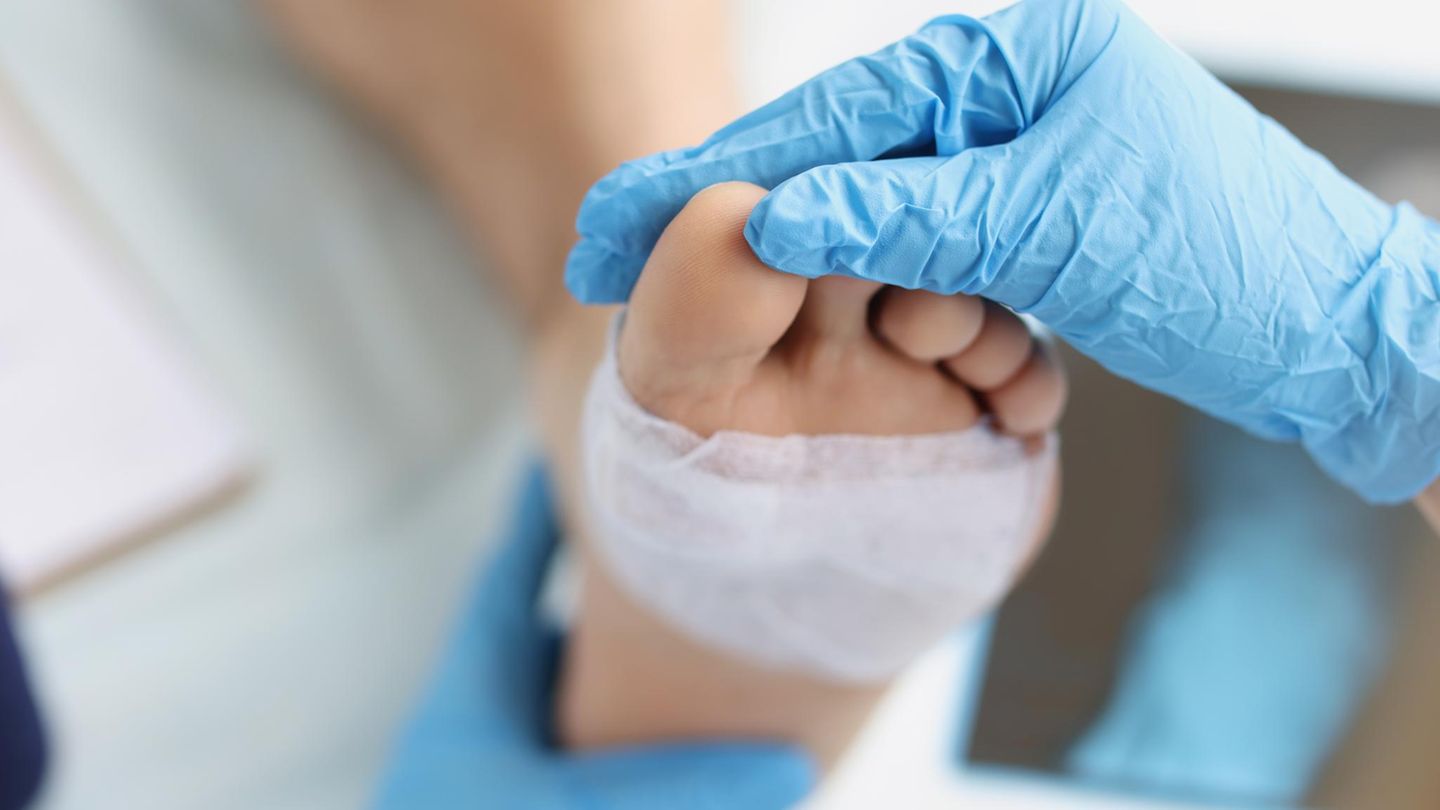 Fußchirurgie: Arzt untersucht Fuß eines Patienten