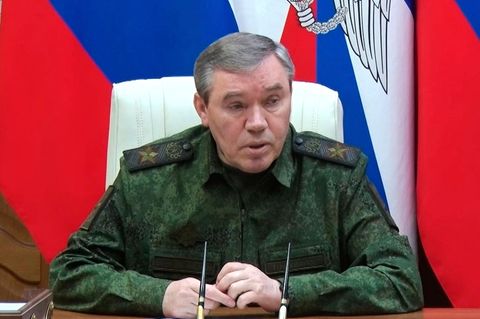 Russlands Generalstabschef Gerassimow während der Pressekonferenz. Im Hintergrund die Russische Flagge.